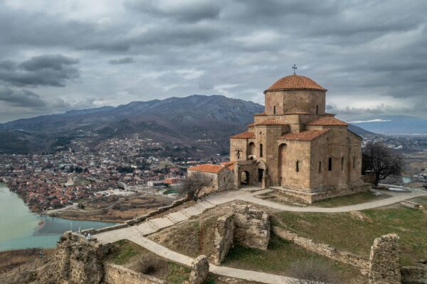 Aerial view of Jvari Monastery, a World Heritage Site in Mtskheta, Georgia, showcasing religious and architectural heritage.