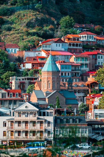 Vibrant view of Tbilisi's historic architecture with colorful houses and lush greenery.