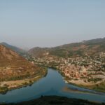 Aerial view of Mtskheta with Aragvi river, showcasing the picturesque landscape of Georgia.