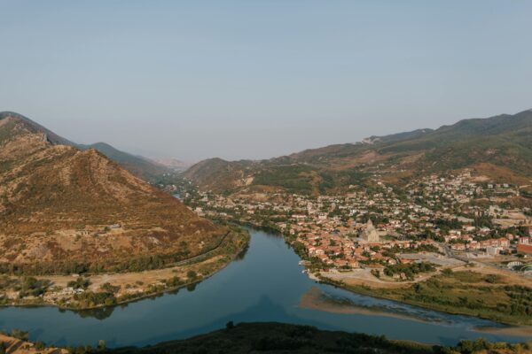 Aerial view of Mtskheta with Aragvi river, showcasing the picturesque landscape of Georgia.